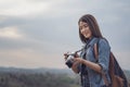 Tourist woman taking photo with her camera in nature Royalty Free Stock Photo