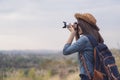 Tourist woman taking photo with her camera in nature Royalty Free Stock Photo