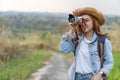 Tourist woman taking photo with her camera in nature Royalty Free Stock Photo
