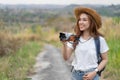 Tourist woman taking photo with her camera in nature Royalty Free Stock Photo