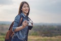 Tourist woman taking photo with her camera in nature Royalty Free Stock Photo