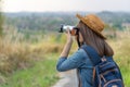 Tourist woman taking photo with her camera in nature Royalty Free Stock Photo