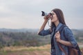 Tourist woman taking photo with her camera in nature Royalty Free Stock Photo