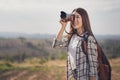 Tourist woman taking photo with her camera in nature Royalty Free Stock Photo