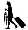 Tourist woman traveler carrying his rolling suitcase, and hold umbrellas silhouette.