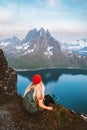 Tourist woman traveling in Norway alone enjoying fjord view hiking in mountains outdoor with backpack healthy lifestyle Royalty Free Stock Photo