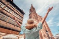 Tourist woman travels in Strasbourg, France. Looking to famous Notre Dame Cathedral Royalty Free Stock Photo
