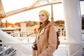 Woman coat with video camera standing near Ferris wheel in Paris Royalty Free Stock Photo