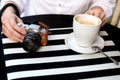 Tourist woman digital camera street cafe terrace girl hat sun vintage travel photo shooting white cup coffee panasonic lumix Royalty Free Stock Photo