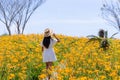 Tourist woman visit Orange day lily flower field on mountain in Taimali of Taitung