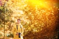 Tourist Woman Walking And Taking Photos In Forest. Lady Photographed Nature. Young Pretty Caucasian Happy Smiling Girl