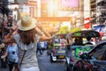 A tourist woman walks down the famous Yaowarat street in Bangkok