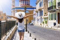 A tourist woman walks down a road in the Vaporia district of Ermoupolis, Syros island