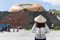 Tourist woman is wearing Non La Vietnamese tradition hat and enjoy sightseeing in lam vien square, Dalat city Vietnam