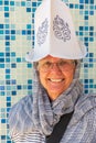 Tourist woman wearing a traditional hat in the market in Kulob