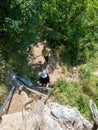 Tourist on wooden stairs on the trail to Inelet and Scarisoara hamlets, Romania