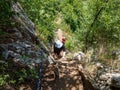 Tourist on wooden stairs on the trail to Inelet and Scarisoara hamlets, Romania