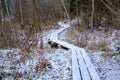 Tourist wooden walking path. Skanaiskalns nature park. November is the first snow in Mazsalaca in Latvia. Royalty Free Stock Photo