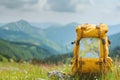 Tourist yellow backpack and map on background green grass nature in mountain, blurred panoramic landscape Royalty Free Stock Photo