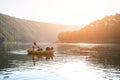 Tourist on yellow packraft boat with red padle