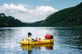 Tourist on yellow packraft rubber boat with red padle