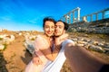 Tourist young couple near Poseidon temple in Greece Royalty Free Stock Photo