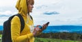 Tourist young girl looks distance on background mount using mobile smartphone, women holding in female hands gadget technology