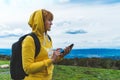 Tourist young girl looks distance on background mount using mobile smartphone, women holding in female hands gadget technology