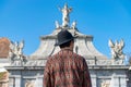 A tourist young man with a hat admiring a fortress gate entrance. A man admiring the 3rd Gate of the Alba-Carolina Fortress in Royalty Free Stock Photo