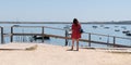 Tourist young woman on Cap Ferret Herbe port at Arcachon berry in France look atlantic beach in web banner template Royalty Free Stock Photo