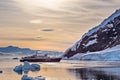 Touristic antarctic cruise vessel among the icebergs with glacie