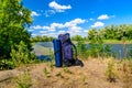 Touristic backpack on a bank of river