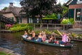 Touristic boat in Giethoorn with joyfull tourists on excursion