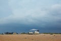 Touristic camp on a sea coast under a dense cloudy sky Royalty Free Stock Photo