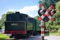 Touristic railway flagman at level crossing stopping car traffic
