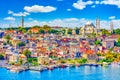 Touristic sightseeing ships in Golden Horn bay of Istanbul and mosque with Sultanahmet district against blue sky and clouds. Royalty Free Stock Photo