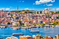 Touristic sightseeing ships in Golden Horn bay of Istanbul and mosque with Sultanahmet district against blue sky and clouds.