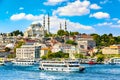 Touristic sightseeing ships in Golden Horn bay of Istanbul and view on Suleymaniye mosque with Sultanahmet district against blue Royalty Free Stock Photo