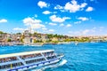 Touristic sightseeing ships in Golden Horn bay of Istanbul and view on Suleymaniye mosque with Sultanahmet district against blue Royalty Free Stock Photo