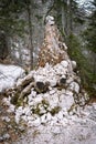 Touristic sign rock pyramid made of old tree`s stem at the touristic path