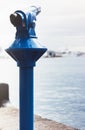 Touristic telescope look at the city and sea with sunset view of Barcelona Spain, close up old blue binoculars on background view Royalty Free Stock Photo