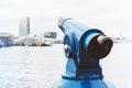 Touristic telescope look at city and sea with sunset view of Barcelona Spain, close up old blue binoculars on background viewpoint Royalty Free Stock Photo