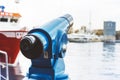 Touristic telescope look at city and sea with sunset view of Barcelona Spain, close up old blue binoculars on background viewpoint Royalty Free Stock Photo