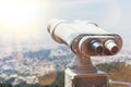 Touristic telescope look at the city with view of Barcelona Spain, close up old metal binoculars on background viewpoint overlook