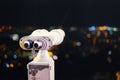 Touristic telescope look at city with view of Barcelona Spain, close up old metal binoculars on background viewpoint, hipster coin