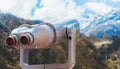 Touristic telescope look at the city with view snow mountains, closeup binocular on background viewpoint observe vision, metal Royalty Free Stock Photo