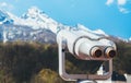 Touristic telescope look at the city with view snow mountains, closeup binocular on background viewpoint observe vision, metal Royalty Free Stock Photo