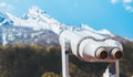 Touristic telescope look at the city with view snow mountains, closeup binocular on background viewpoint observe vision, metal Royalty Free Stock Photo