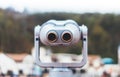 Touristic telescope look at the city with view snow mountains, closeup metal binocular on background viewpoint observe vision Royalty Free Stock Photo