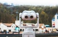 Touristic telescope look at the city with view snow mountains, closeup metal binocular on background viewpoint observe vision Royalty Free Stock Photo